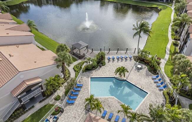 Beautiful drone shot overview of pool, clubhouse and lake area