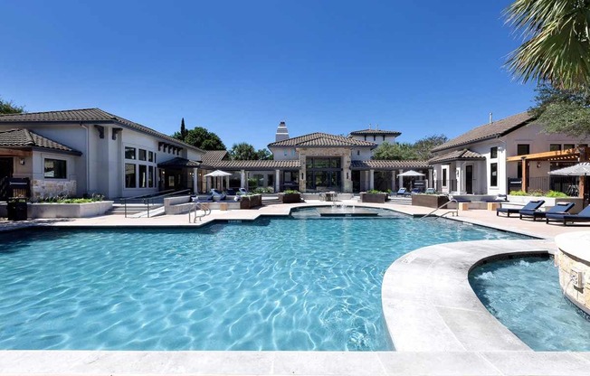 a swimming pool with a house in the background