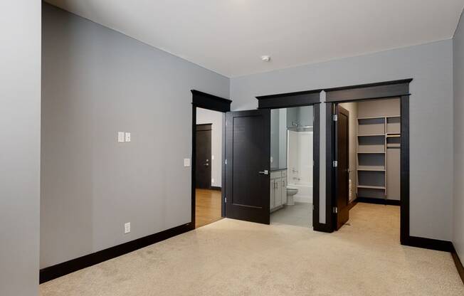 master bedroom with a walk in closet and a bathroom