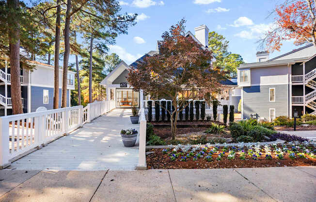 A white picket fence leads to a building with a sign that reads "1101.".