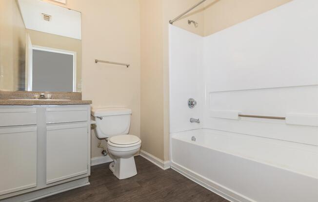 a white tub sitting next to a sink