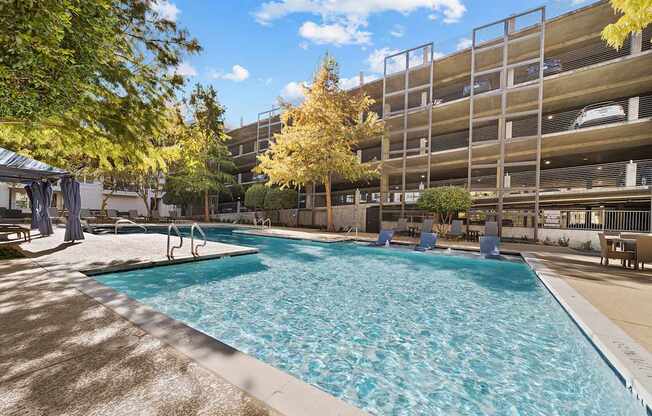 a swimming pool in front of an apartment building