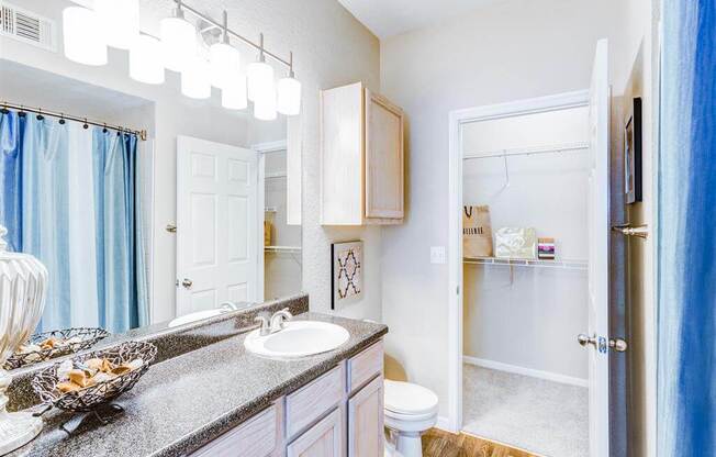Walk in closet through bathroom at The Villas at Katy Trail in Uptown Dallas, TX, For Rent. Now leasing Studio, 1, 2 and 3 bedroom apartments.