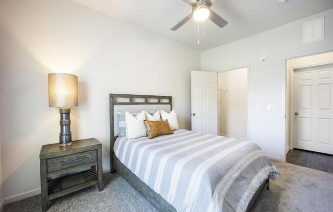 a bedroom with a bed and a ceiling fan at The Maddox Apartments, Centerton