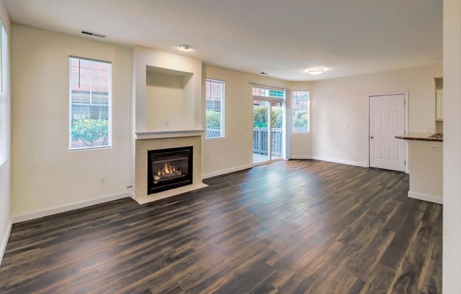 a living room with a fireplace and wooden floors