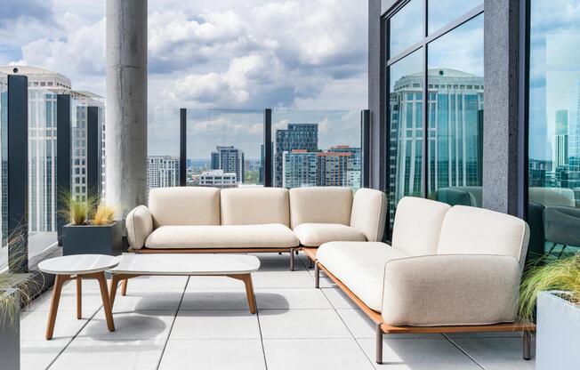 An elevated outdoor lounge frames sweeping Atlanta skyline views, offering a refined setting to relax or gather above the city.
