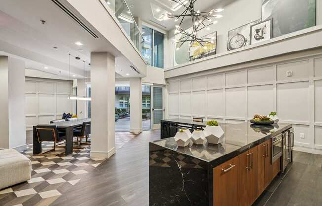 A modern kitchen with a black countertop and wooden cabinets.