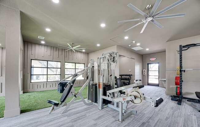the choices apartments fitness center with cardio equipment and grassy area