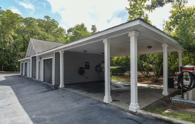 the front of a car dealership with a covered parking lot