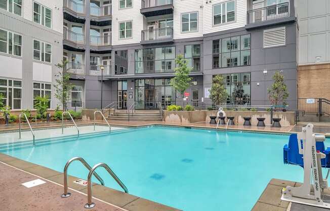 a swimming pool in front of an apartment building