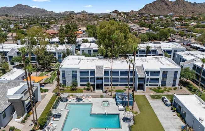 A large building with a pool in front of it.