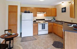 a kitchen with a stove and a refrigerator