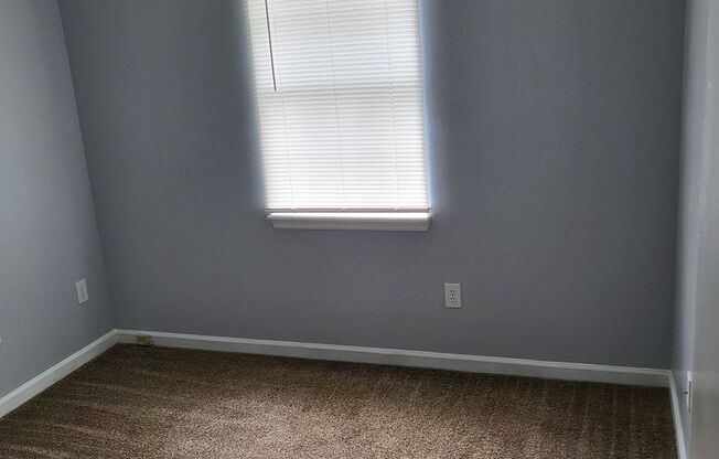 Single family home with covered front porch and back patio.