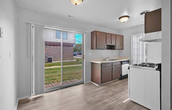 Fully equipped apartment kitchen with modern appliances at Farmbrooke Manor Clinton Township MI