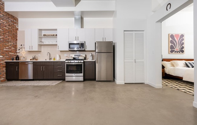 a kitchen with stainless steel appliances and white cabinets