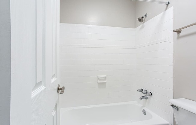 Spacious tub and shower with tiled walls at Parkside at Sandy Springs Atlanta, GA
