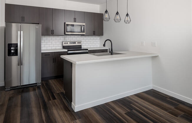 a kitchen with a large island and stainless steel appliances at The Landing at 1001 NP, Fargo, North Dakota 58102