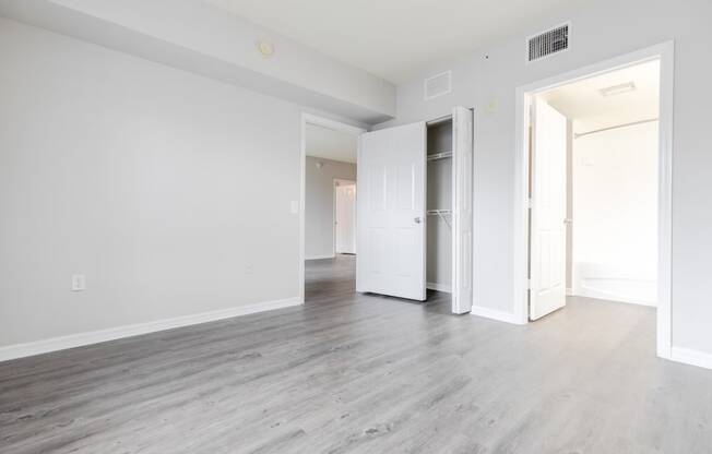 a bedroom with hardwood floors and white walls at Heritage Bay, Florida