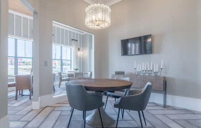 a dining room with a table and chairs and a tv