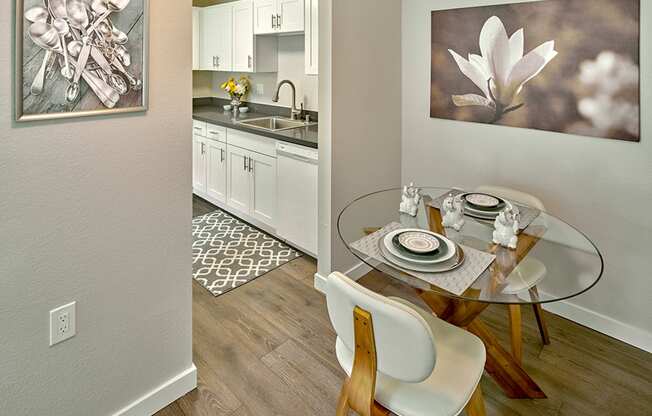 a dining room with a glass table and a kitchen at Quartz Creek, Washington, 98043