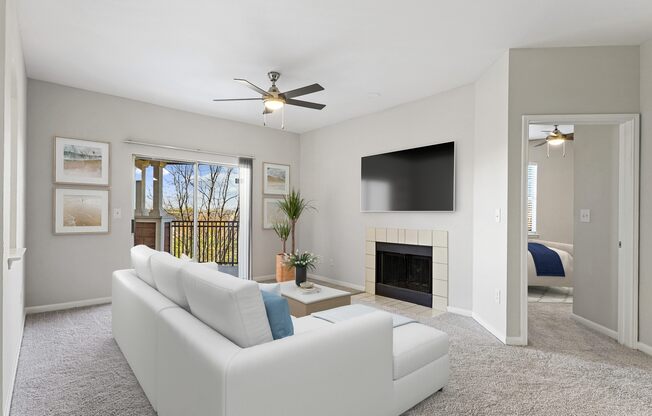 a living room with a white couch and a ceiling fan at The Legends at Eagle Mountain Lake, Fort Worth, Texas