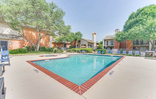 A large swimming pool surrounded by a red brick border at Copper Hill Apartments, Texas, 76021