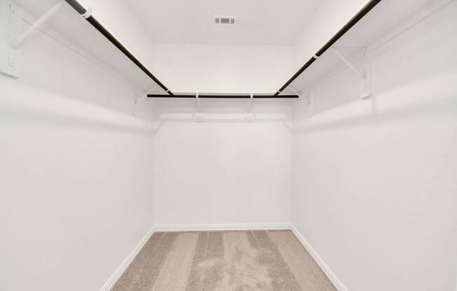 an empty room with white walls and carpet
