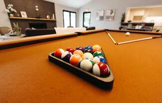 a pool table in a living room with billiard balls