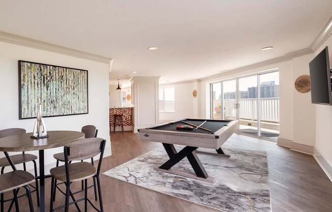 A room with a pool table and a painting on the wall.