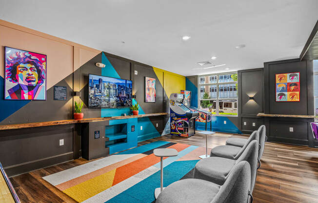 a living room with couches and chairs and a play area with a video game