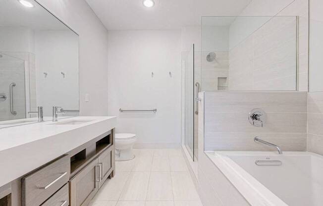 A white bathroom with a walk in shower.