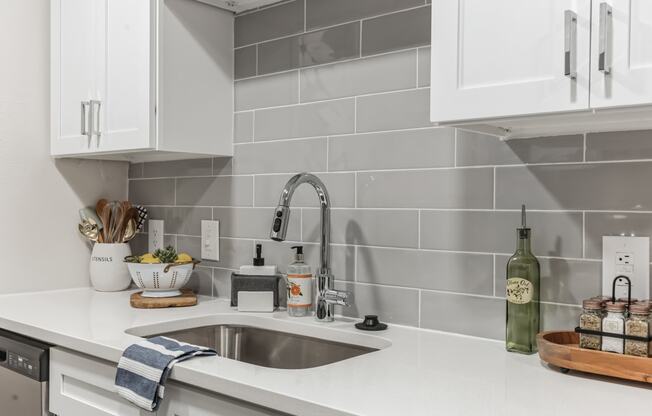 a kitchen with white counter tops and a sink at St. Andrews Reserve, Wilmington, NC