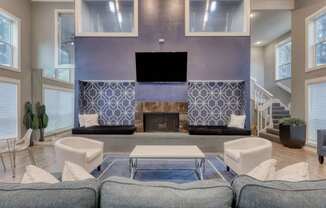 A modern living room with a fireplace and a television.