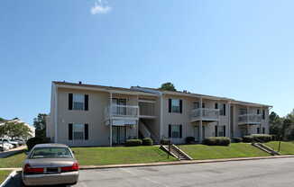 autumn chase apartment building with ample parking out front