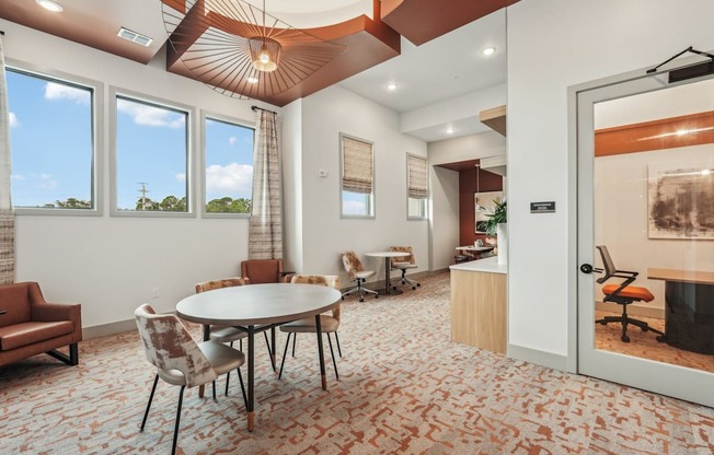 Co-working room with communal table and private coworking rooms