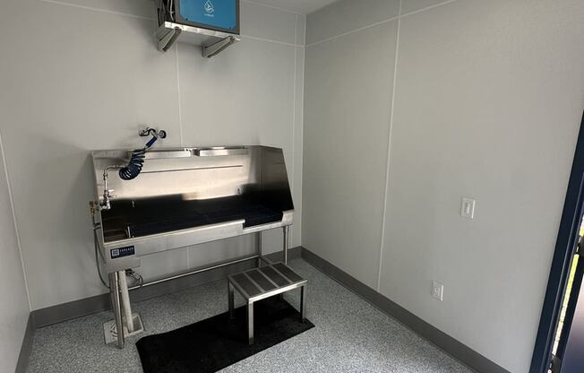 a patient room with a sink and a mirror