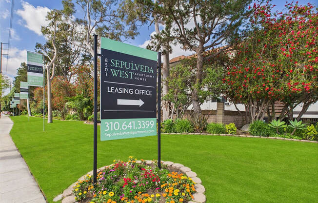 A sign for the leasing office of Sepulveda West apartments.