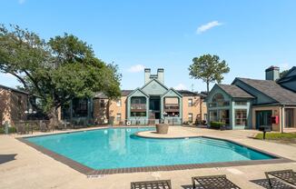 a swimming pool with apartments in the background