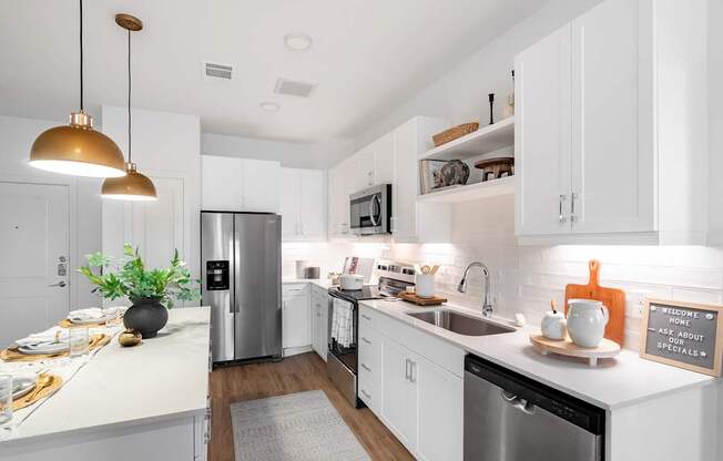 A kitchen with white cabinets and a black dishwasher.