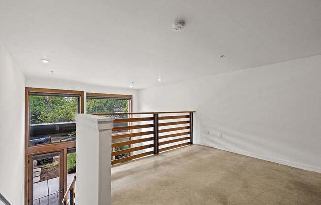 A white room with a window and a balcony.