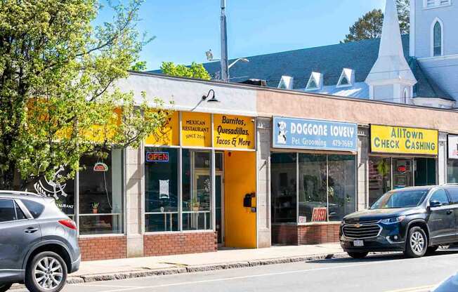 A yellow and white building with a sign that says