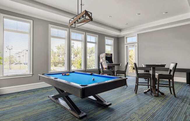 A pool table in a room with a chair and a dining table.