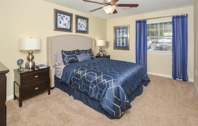 Bedroom with cozy bed and lights at Harvard Place Apartment Homes by ICER, Lithonia, 30058