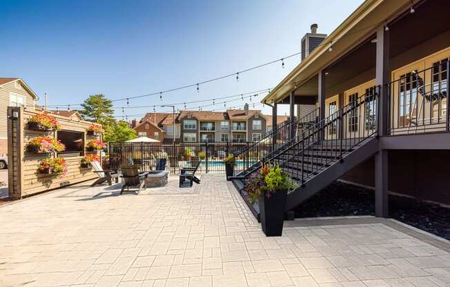 a patio with tables and chairs and a pool