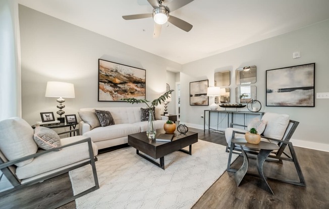 a living room with couches and chairs and a table