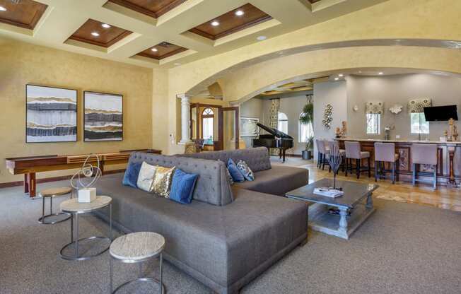 a living room with coffered ceilings and a piano in the background