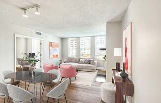 A living room with a table and chairs.