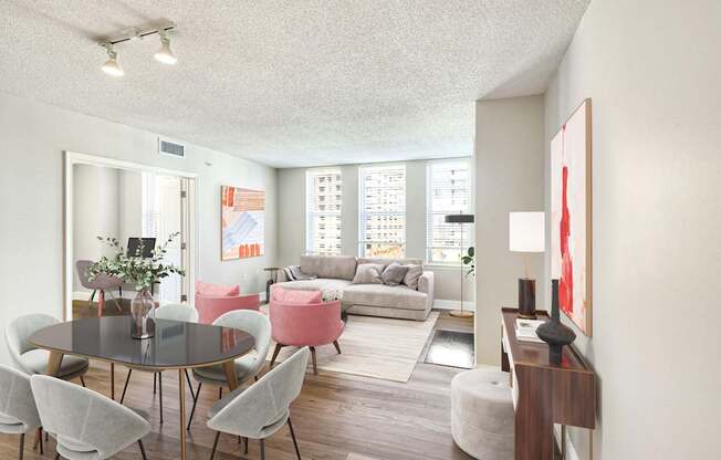 A living room with a table and chairs.