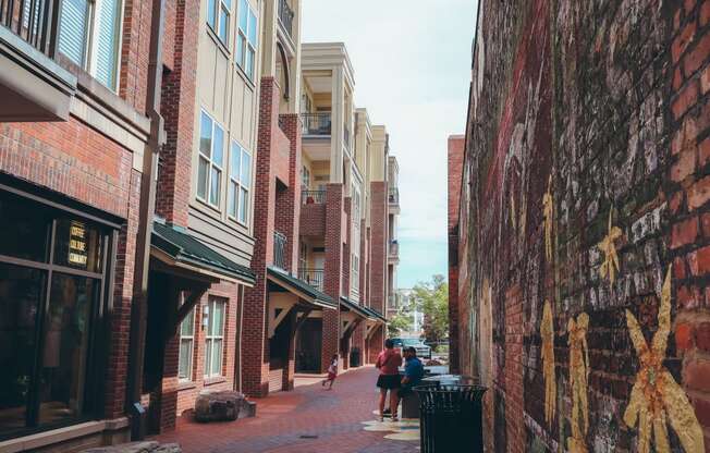 people walking down a city street next to brick buildings