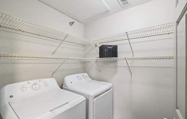A small laundry room with a washer and dryer.